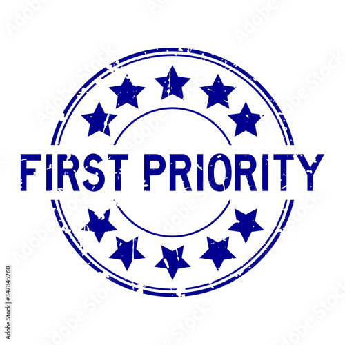 Grunge blue first priority word with star icon round rubber seal stamp on white background