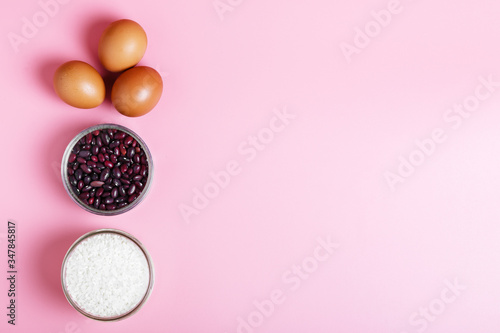  Eggs, rice, beans on a pink background. Concept of food delivery and food donation during quarantine isolation during the coronavirus pandemic. online grocery shopping. copy space
