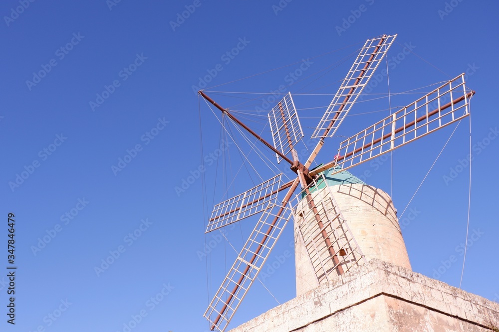 Authentic antient mill against sun. Village of Xaghra, island of Gozo, Maltese archipelago Authentic antient mill against sun. Village of Xaghra, island of Gozo, Maltese archipelago