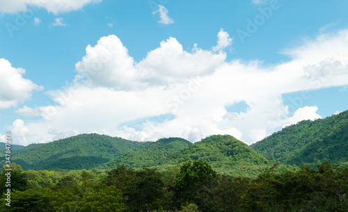Green mountains and beautiful sky clouds under blue sky. Outdoor landscape natural background. © Lifestyle Graphic