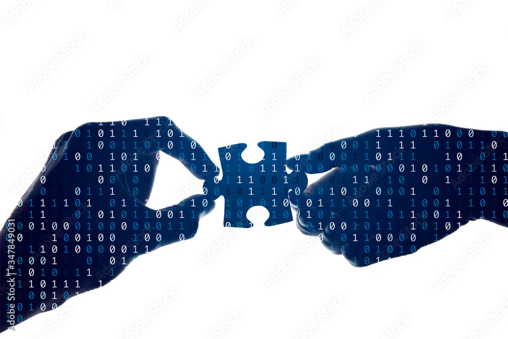 Silhouette of a hands holding a jigsaw puzzle piece with binary background Silhouette of a hands holding a jigsaw puzzle piece with binary background