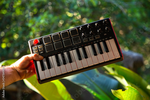 Holding midi keyboard in a garden