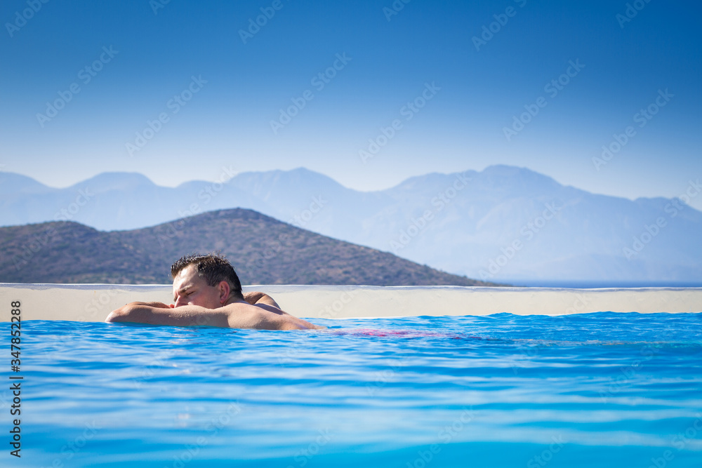 Man relaxing in the water with amazing view, Greece
