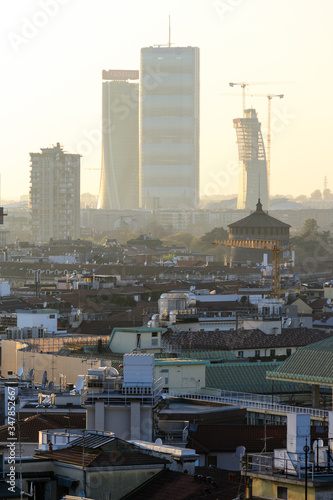 Milano  Italy  march 22  2019  from the roof top of the Duomo church the view of the city at sunset time  in the back ground the three new towers  one still in construction  of the Citylife district