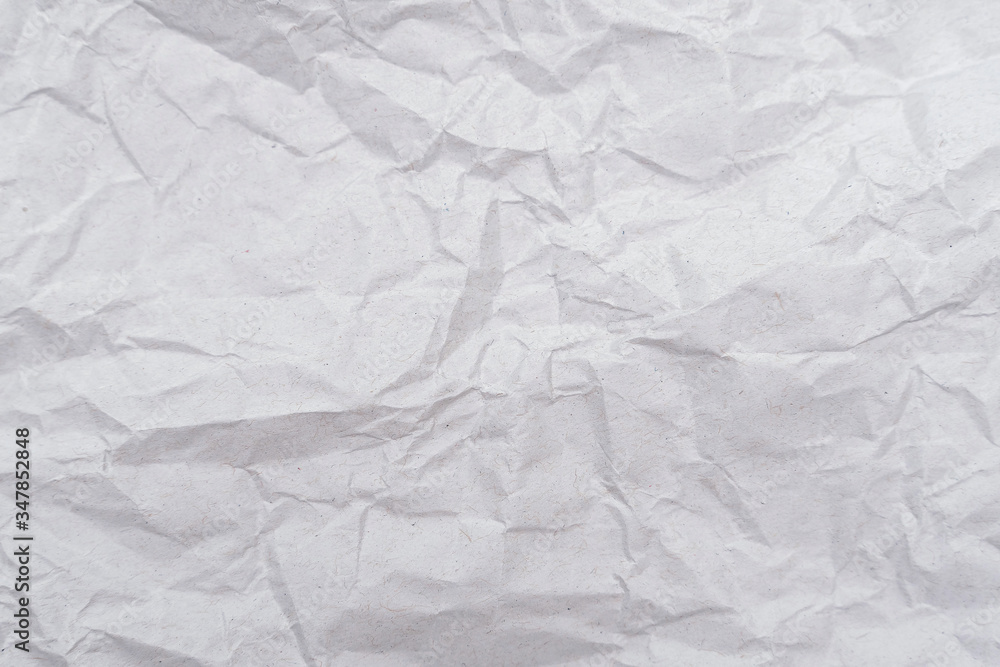 Fototapeta premium White crumpled paper texture. Abstract paper pattern for background. Close-up.