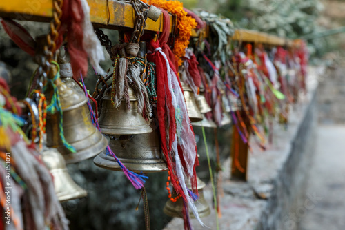 metal bells hang on chains in a Hindu temple. Dakshinkali Temple in Pharping, Nepal. photo