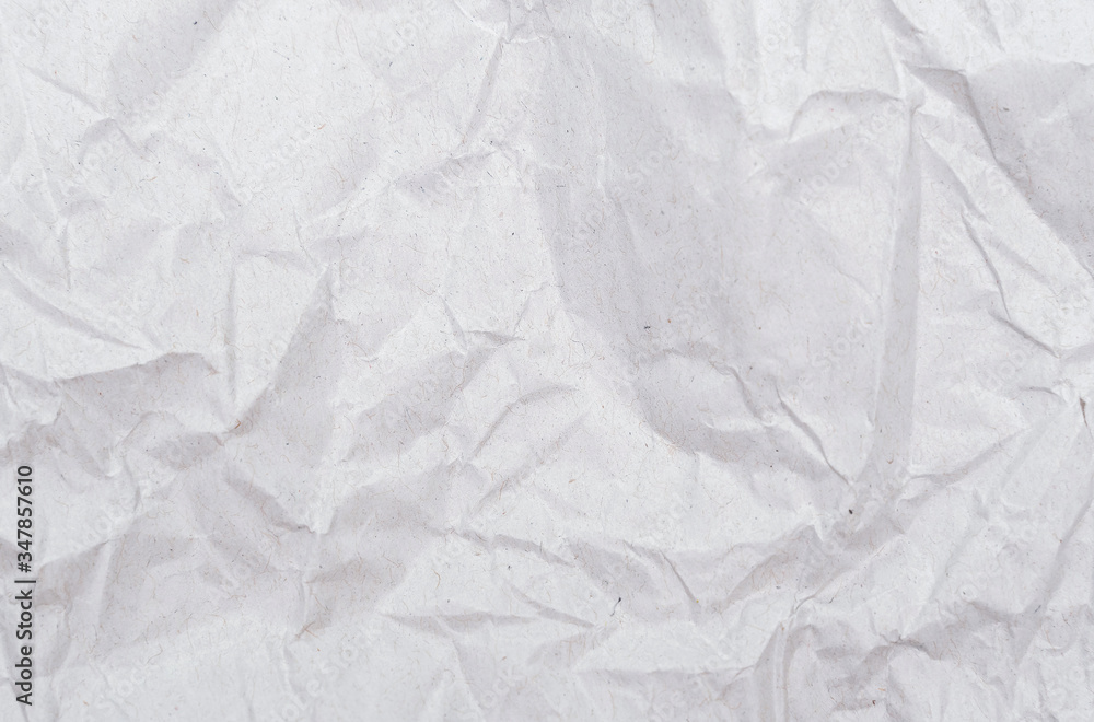 Fototapeta premium White crumpled paper texture. Abstract paper pattern for background. Close-up.