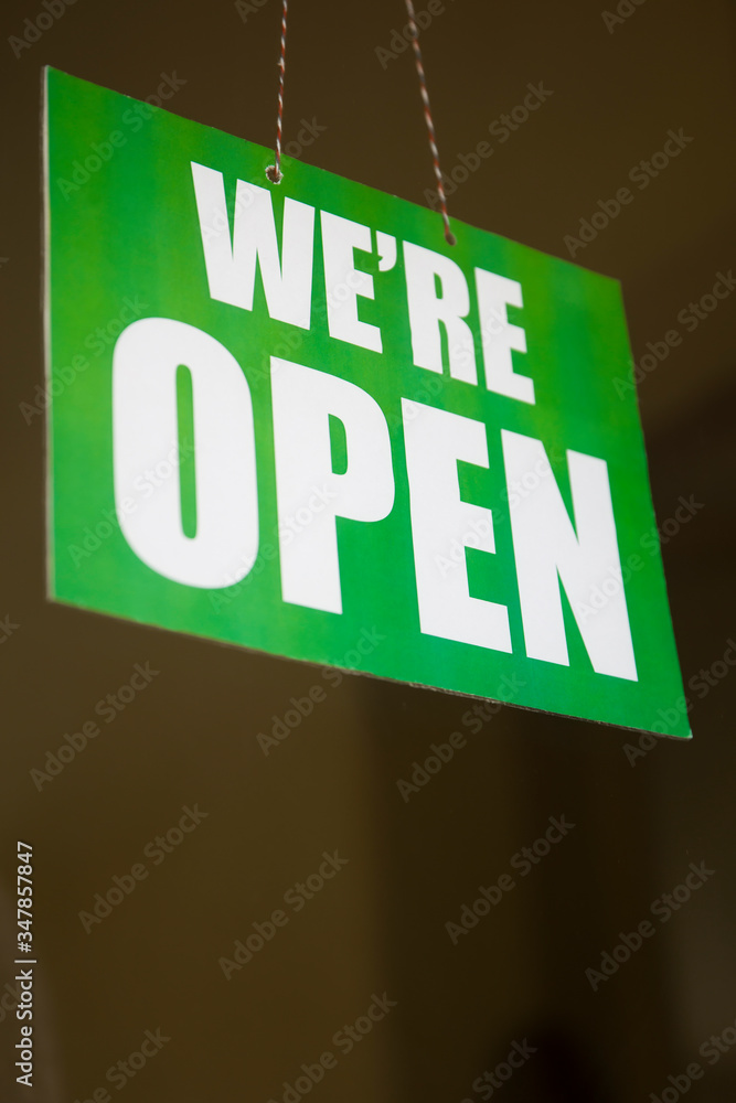 Open sign on the glass of the door at store Open sign on the glass of the door at store