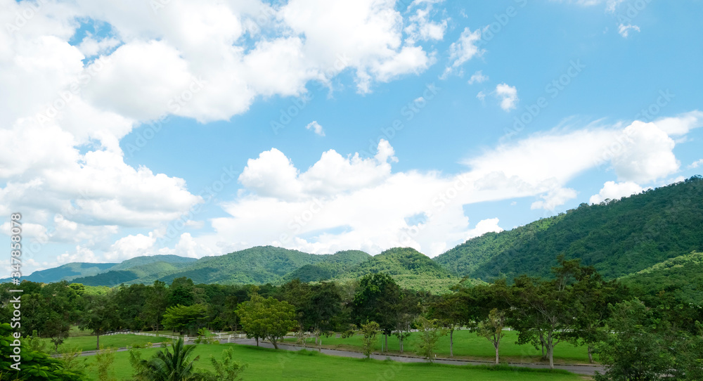 Green mountains and beautiful sky clouds under blue sky. Outdoor landscape for background.