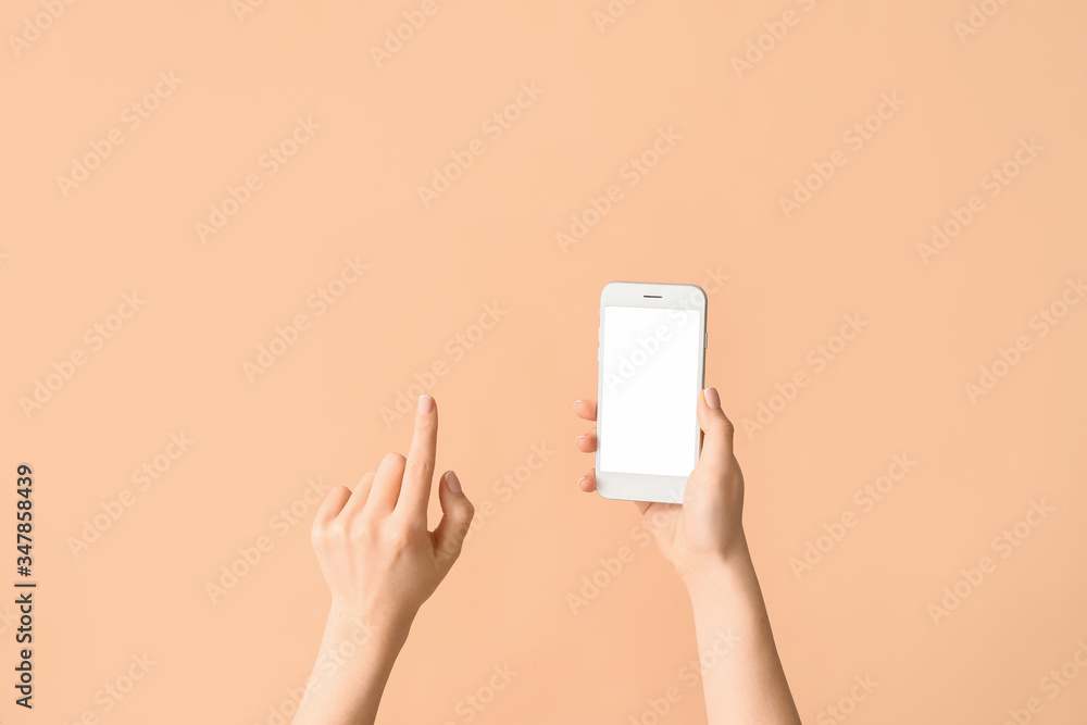 Female hands with mobile phone on color background Female hands with mobile phone on color background