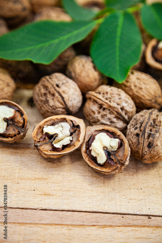 Walnuts and leaves on a table. Walnuts and leaves on a table.