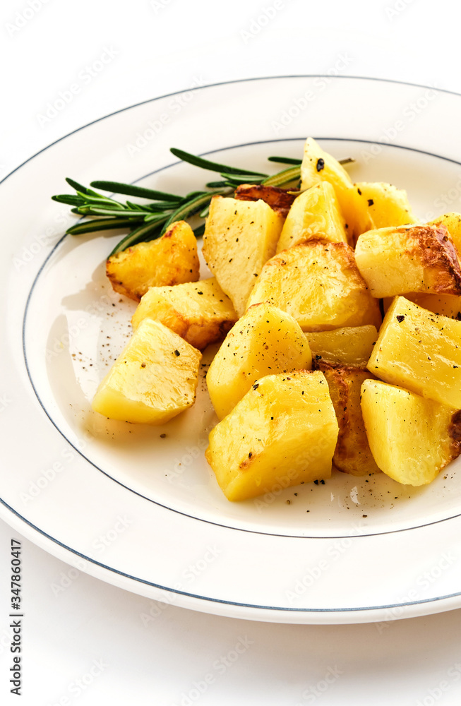 Fried baked potatoes with rosemary on a white plate Fried baked potatoes with rosemary on a white plate