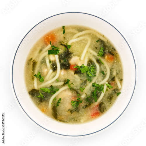 Noodle soup with chicken broth, parsley and carrots.