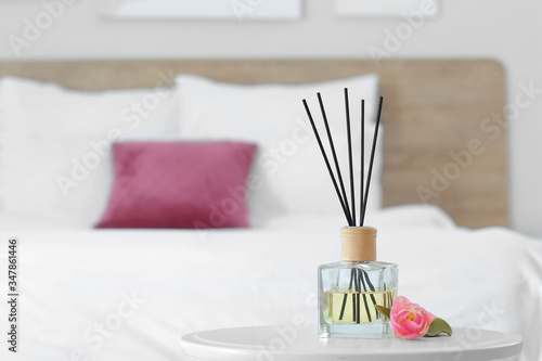 Reed diffuser on table in b...