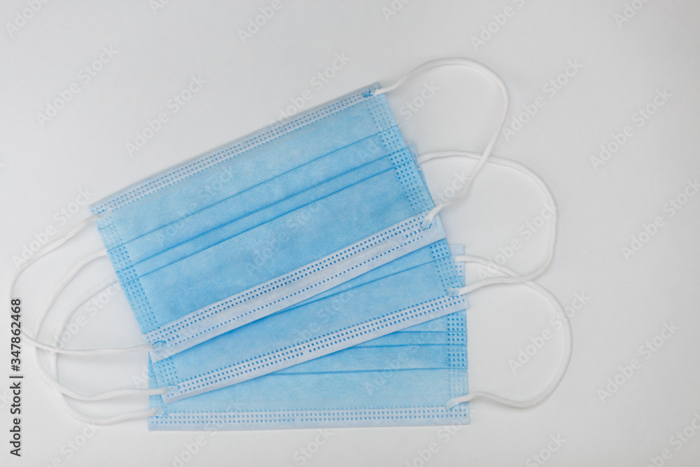 three medical protective masks on a white background three medical protective masks on a white background