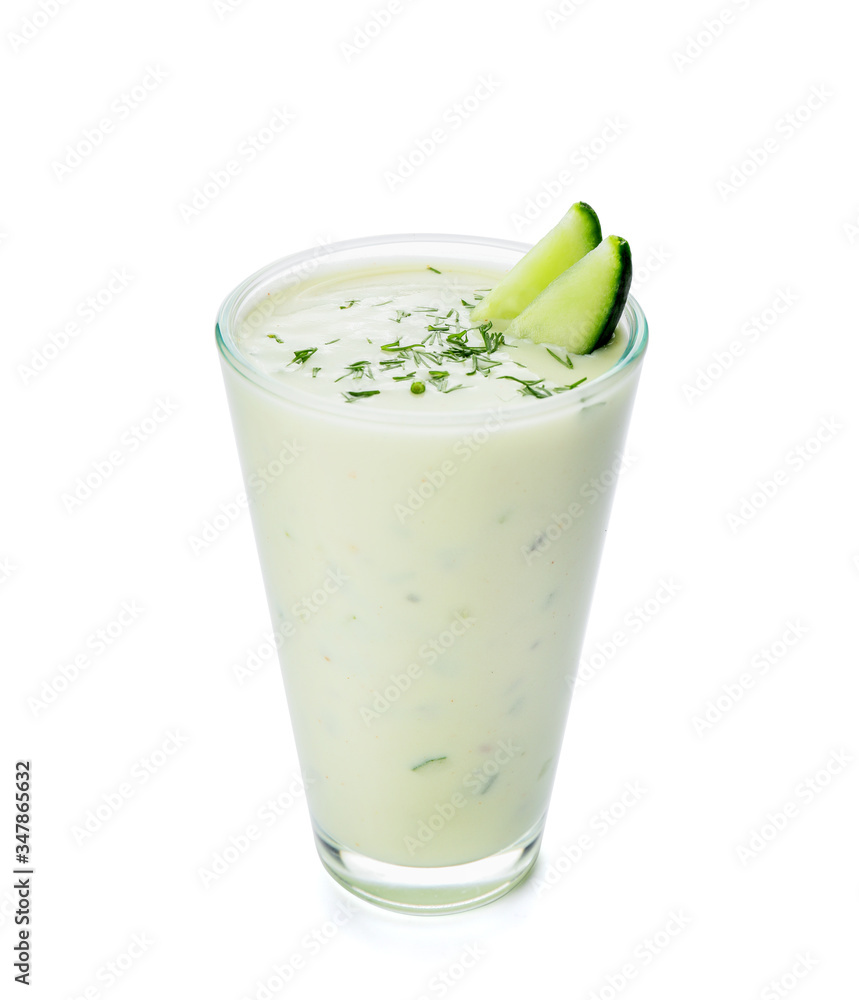 Glass with cold cucumber soup on white background Glass with cold cucumber soup on white background