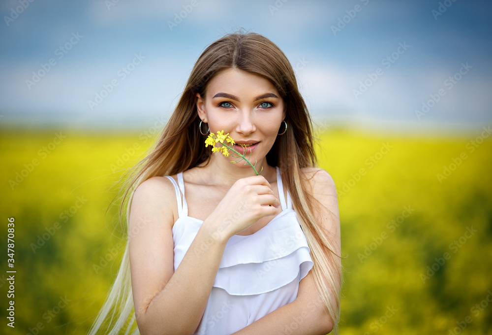 Beautiful woman in a white dress in a field Beautiful woman in a white dress in a field