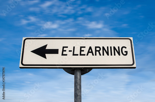 White sign with arrow - E-learning. Direction sign. Crossroads Road Sign, arrow on blue sky background. Arrows on a pole pointing in one direction. Learning in that direction. Never stop learning.