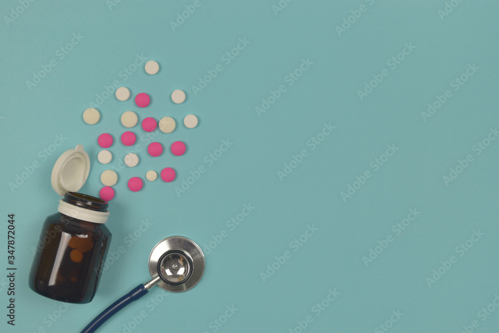 To view of pills with stethoscope on blue background. copy space.