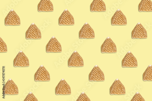 Pattern of golden sand pyramids on a beige background. Minimal tourism background texture. Creative layout