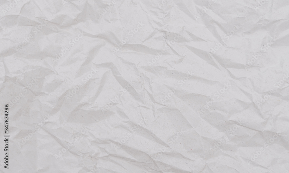 Fototapeta premium White crumpled paper texture. Abstract paper pattern for background. Close-up.