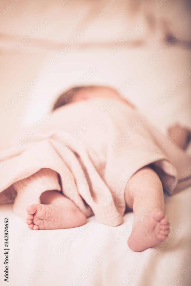 Close up picture of newborn baby feet. Sleeping newborn baby on a light blanket. Close up picture of newborn baby feet. Sleeping newborn baby on a light blanket.