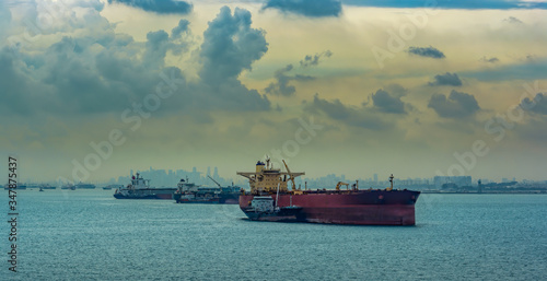 Canvas Print Loading anchored oil supertanker via a ship-to-ship oil transfer (STS) from raid