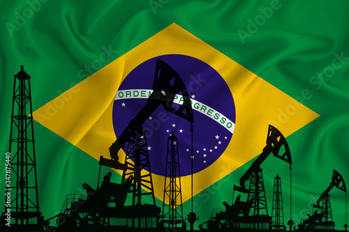 Silhouette of drilling rigs and oil derricks on the background of the flag of Brazil. Oil and gas industry. The concept of oil fields and oil companies.