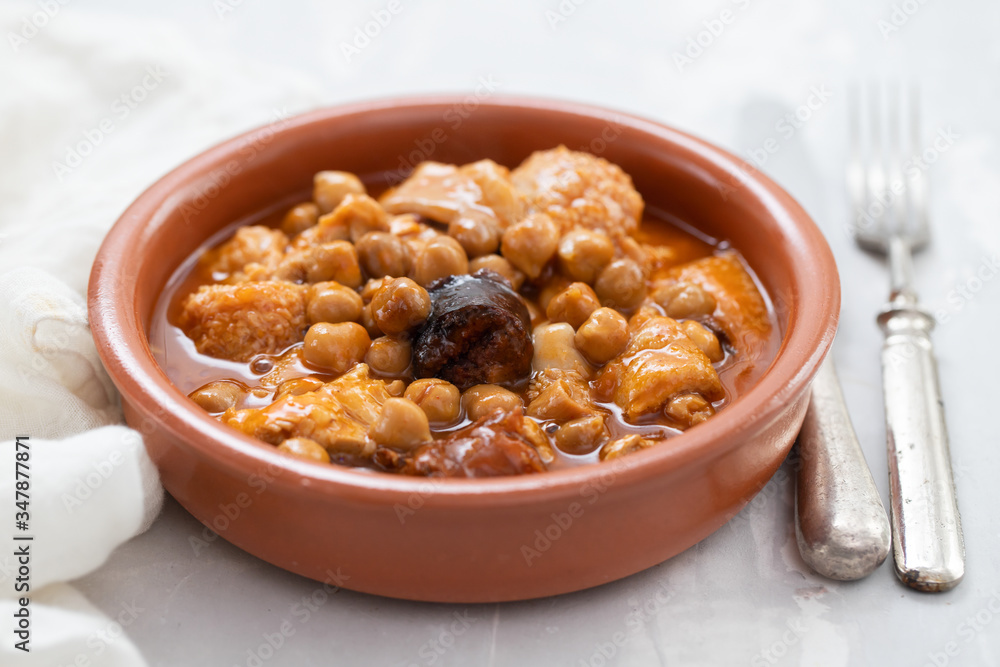 spanish dish callos, beef tripe stew with chickpeas, morcilla and chorizo in ceramic bowl spanish dish callos, beef tripe stew with chickpeas, morcilla and chorizo in ceramic bowl