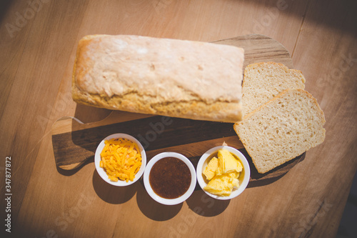 Close up image of a freshly baked bread with home made appricot preserve and butter photo