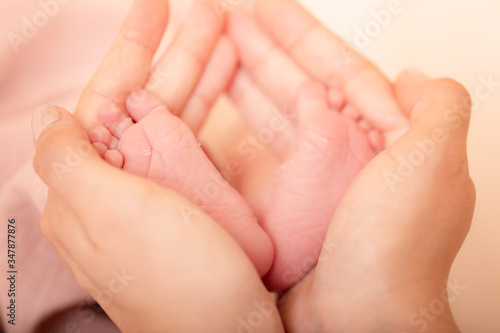 Close up picture of newborn baby feet. Sleeping newborn baby on a light blanket.