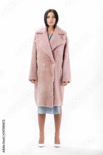 girl in a fur coat on a white background for a catalog