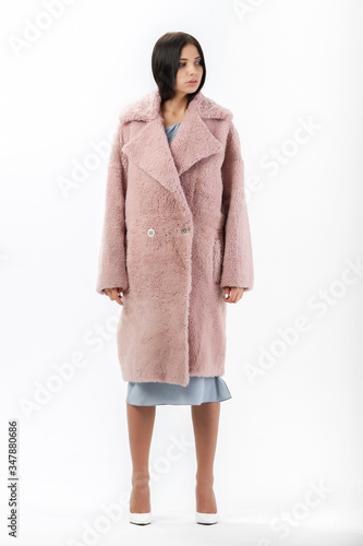 girl in a fur coat on a white background for a catalog