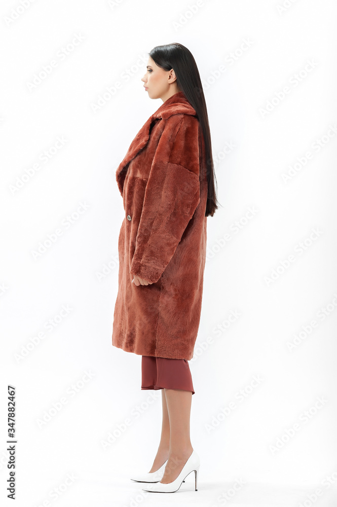 girl in a fur coat on a white background for a catalog