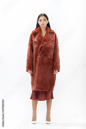 girl in a fur coat on a white background for a catalog