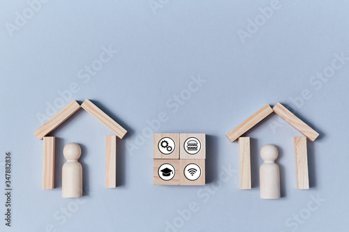 Smart home. Remote control. Online managing. Wooden roof and people figures on blue backdrop. Cubes with symbols © oleg_chumakov