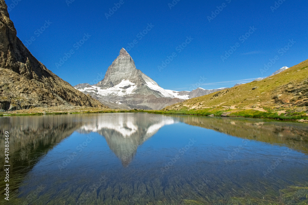 Beautiful Swiss Alps landscape with Stellisee lake and Matterhorn mountain reflection in water, summer mountains view, Zermatt, Switzerland
