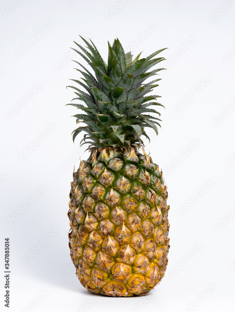 Whole fresh pineapple fruit on white background