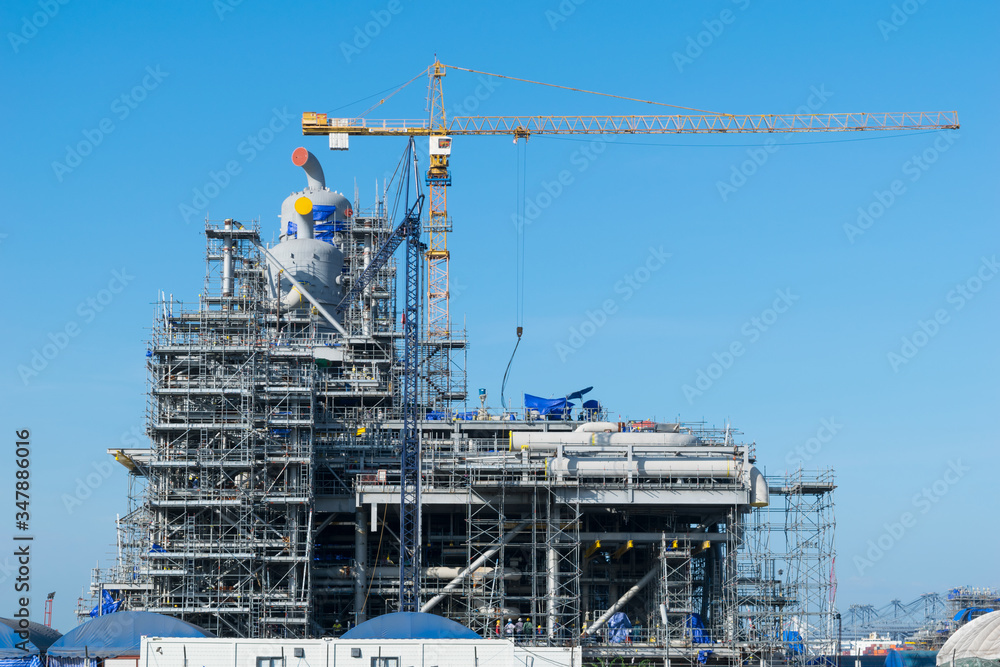 Construction Industry oil rig refinery working site with blue sky background Construction Industry oil rig refinery working site with blue sky background
