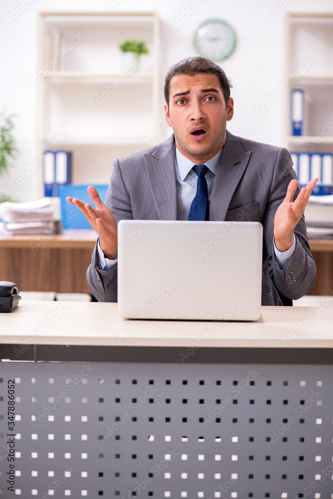 Young male businessman unhappy with excessive work Young male businessman unhappy with excessive work