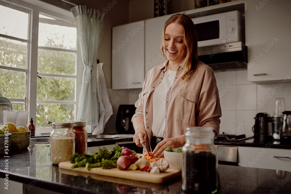 Woman cooking vegetable summer salad in the home kitchen - cooking a healthy vegan meal at home Woman cooking vegetable summer salad in the home kitchen - cooking a healthy vegan meal at home