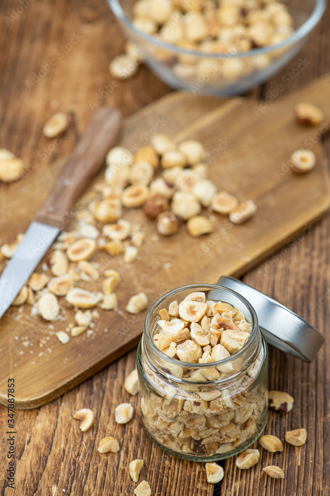 Fototapeta premium Portion of freshly chopped Hazelnuts (close up; selective focus)