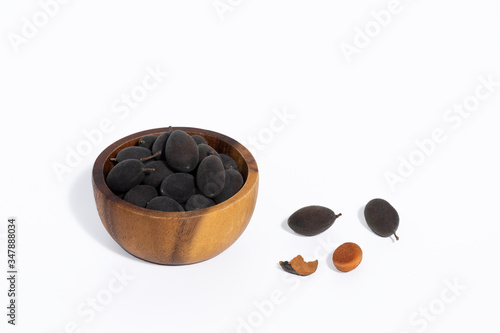 Dialium cochinchinensis, rare tropical fruit on white background photo