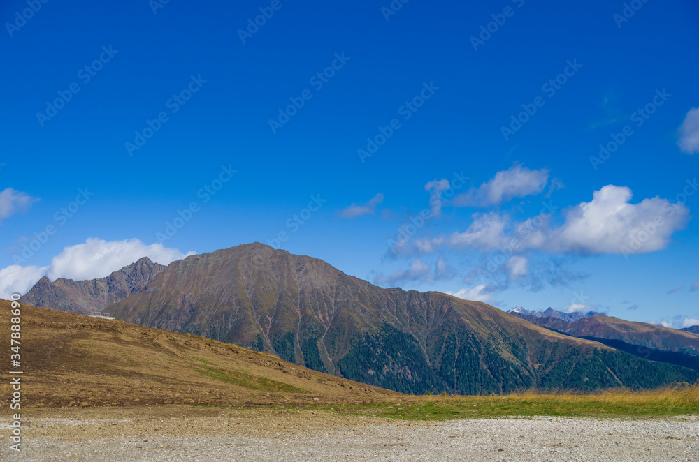 holidays in the mountains, living in the mountains, mountain peaks in the sunlight, green woods and rocks holidays in the mountains, living in the mountains, mountain peaks in the sunlight, green woods and rocks