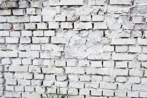 Beautiful white painted brick wall shabby old with cracks in the loft style with seams. Texture, background