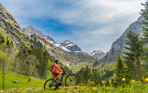 pretty senior woman riding her electric mountain bike the Oy Tal Valley near Oberstdorf, Allgau Alps, Bavaria, Germany © Uwe