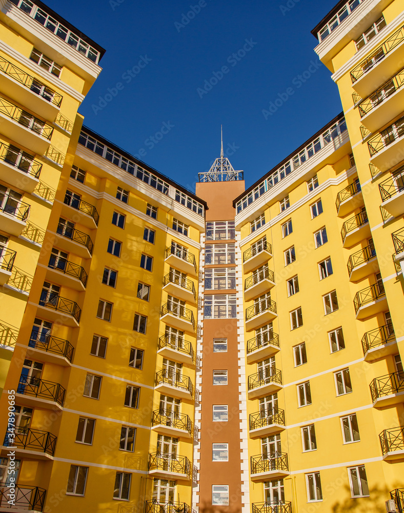 New-constructed multi-storey residential building. multi-storey residential house in brown and beige colors. Modern residential construction. Residential fund