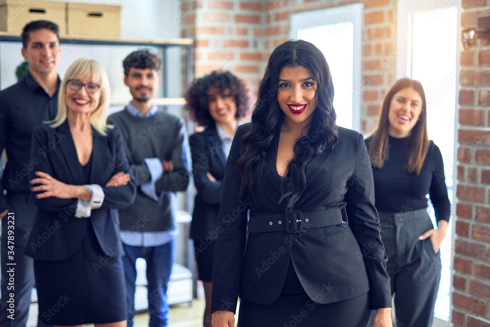 Obraz premium Group of business workers smiling happy and confident. Posing together looking at the camera, young beautiful woman with smile on face at the office