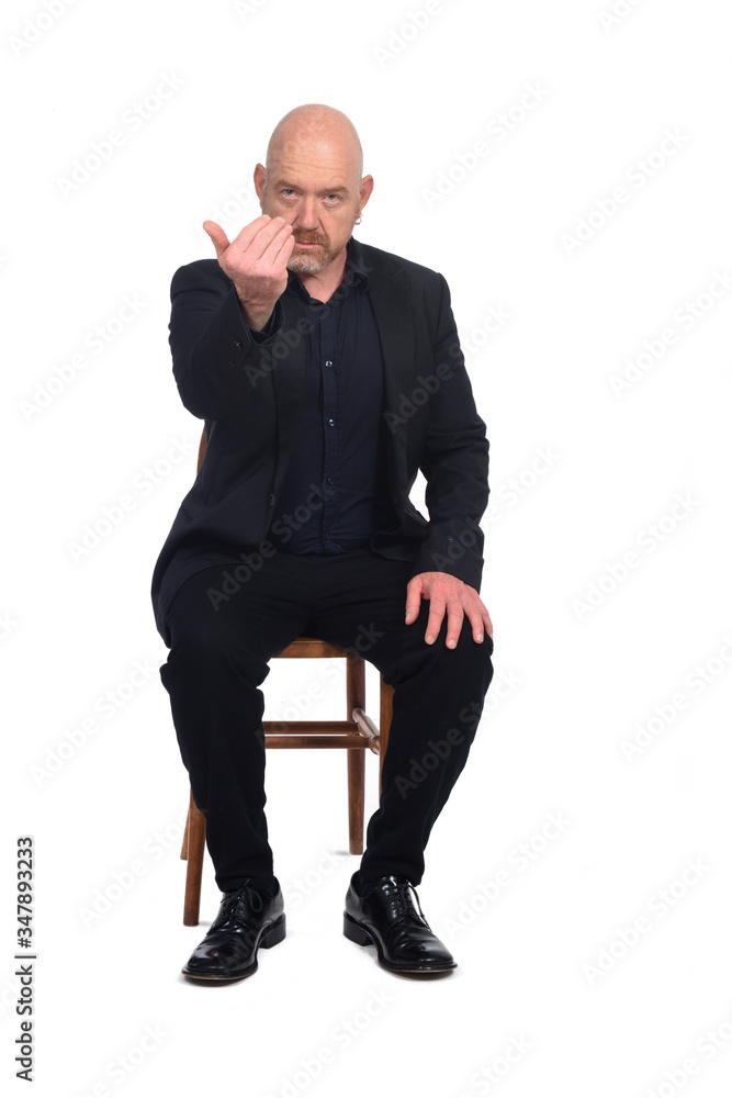 bald man sitting in a chair that says go to him bald man sitting in a chair that says go to him