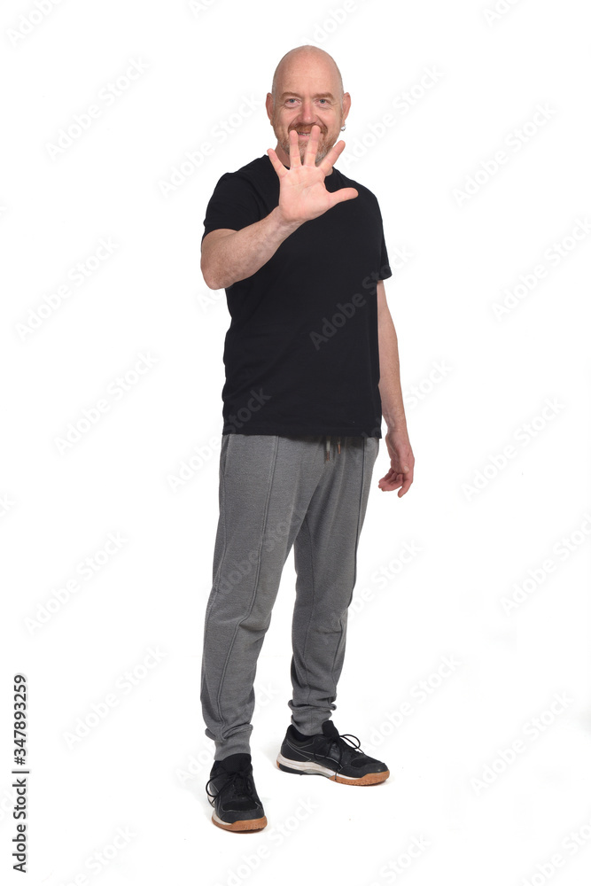 bald man with sportswear making number five by hand on white background bald man with sportswear making number five by hand on white background